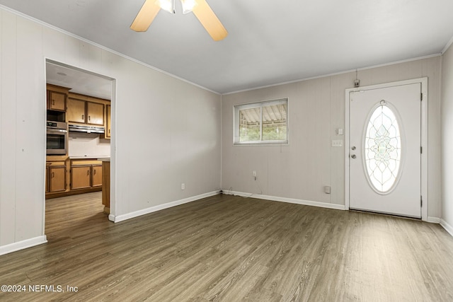 foyer with crown molding, ceiling fan, and wood-type flooring