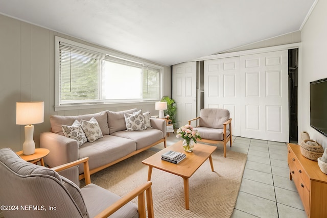 tiled living room featuring vaulted ceiling