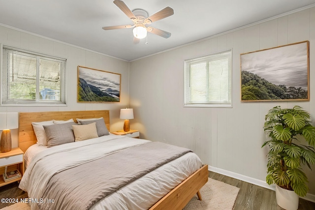 bedroom featuring ceiling fan, ornamental molding, and dark hardwood / wood-style flooring