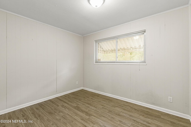 spare room featuring ornamental molding and hardwood / wood-style floors