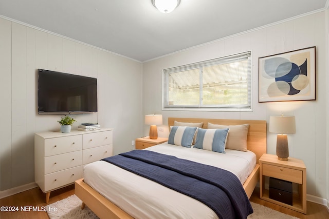 bedroom with crown molding and wood-type flooring