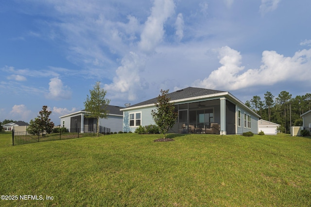 rear view of property with a lawn and ceiling fan