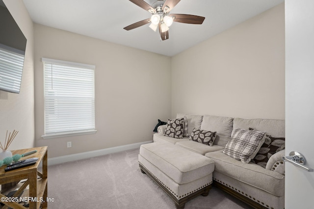 carpeted living room featuring ceiling fan