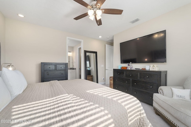 carpeted bedroom featuring ensuite bathroom and ceiling fan