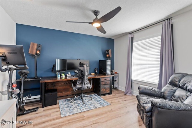 office area with ceiling fan, light hardwood / wood-style flooring, and a textured ceiling