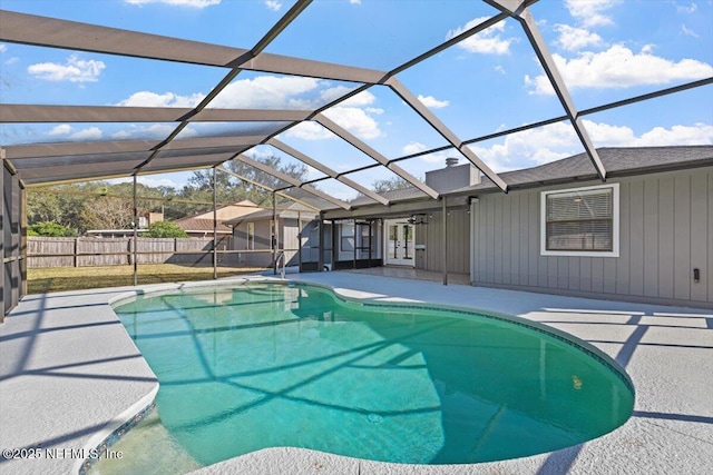 view of swimming pool with a patio area and glass enclosure