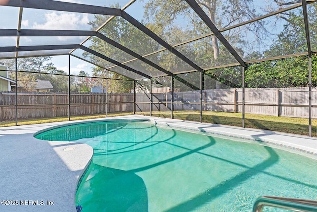 view of pool featuring glass enclosure