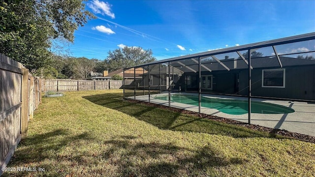 view of pool with a lanai, a lawn, and a patio