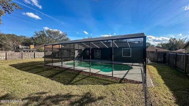 view of swimming pool with a lanai, a lawn, and a patio