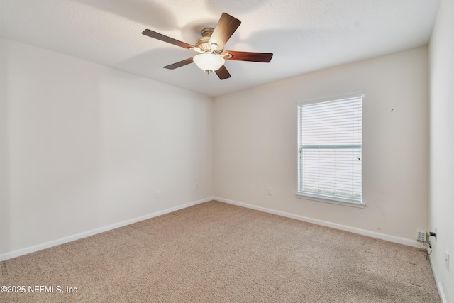 spare room featuring ceiling fan and light colored carpet