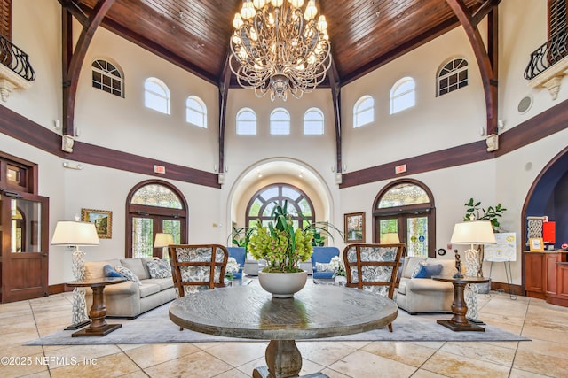 dining room with a notable chandelier, plenty of natural light, and wooden ceiling