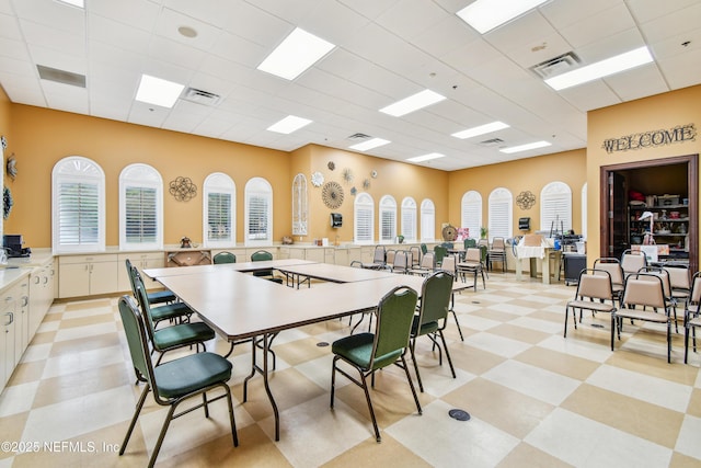 dining space featuring a drop ceiling