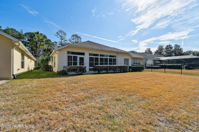 rear view of property with a yard