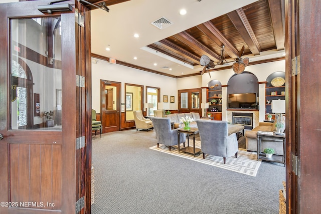 living room featuring ornamental molding, wooden ceiling, beamed ceiling, and carpet