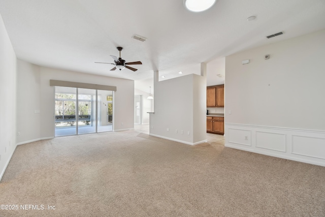 carpeted spare room with ceiling fan