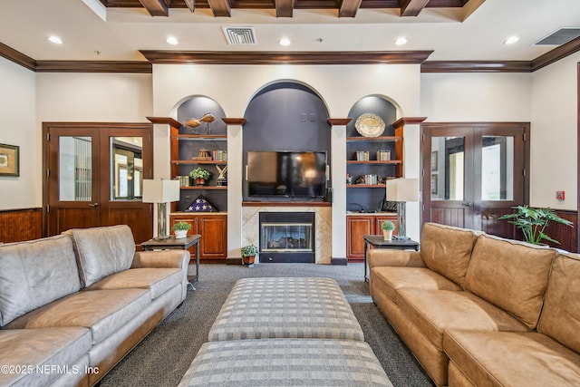 carpeted living room with a premium fireplace, crown molding, and french doors