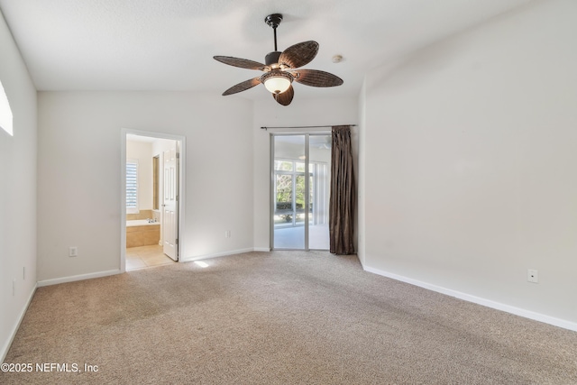 carpeted spare room with ceiling fan