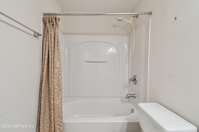 bathroom featuring shower / tub combo with curtain and toilet