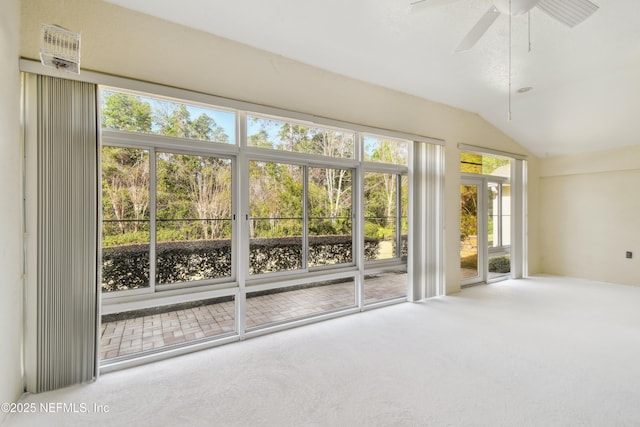 interior space featuring ceiling fan, lofted ceiling, and carpet