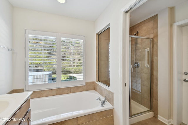 bathroom featuring vanity and independent shower and bath