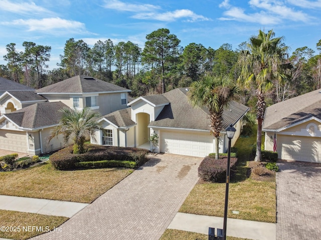 front facade featuring a garage and a front yard