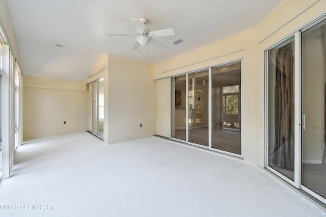 unfurnished sunroom featuring ceiling fan