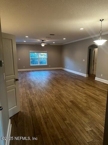 unfurnished room with ornamental molding and dark hardwood / wood-style flooring