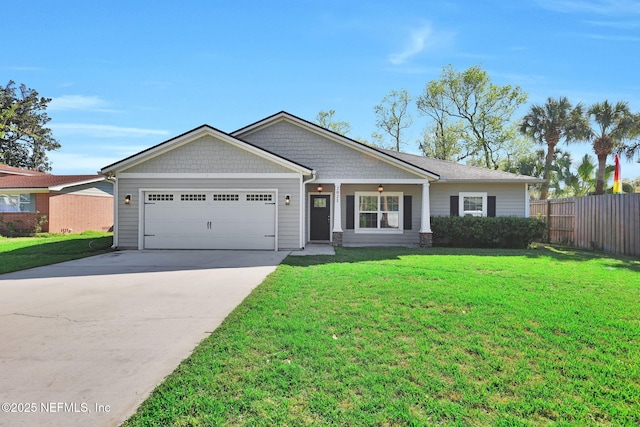 view of front of property with driveway, a front yard, a garage, and fence