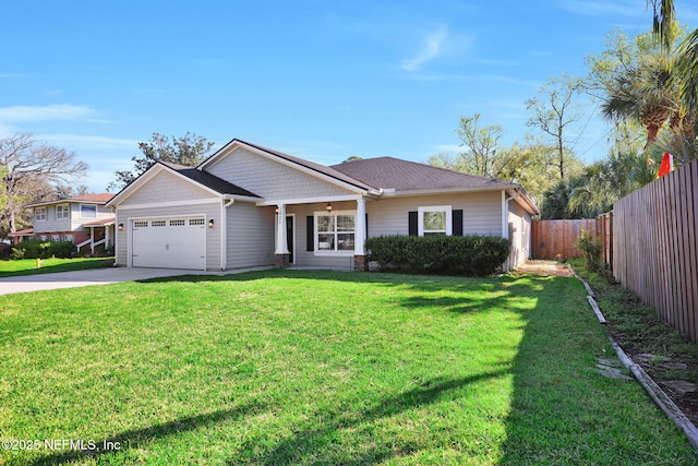 view of front of property featuring a front lawn, concrete driveway, a garage, and fence