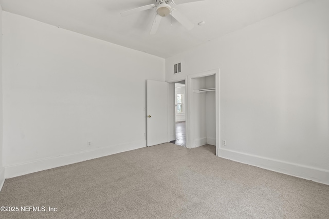 unfurnished bedroom with ceiling fan, carpet floors, and a closet