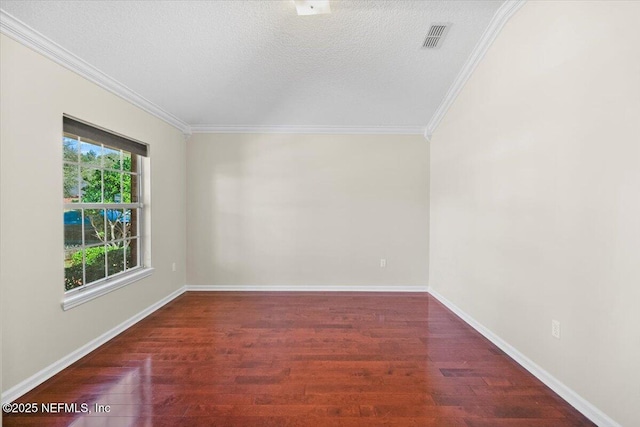 empty room with dark hardwood / wood-style flooring, ornamental molding, and a textured ceiling