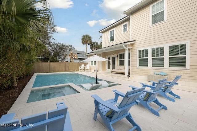 view of swimming pool featuring an in ground hot tub and a patio