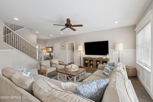 living room with stairs, recessed lighting, wainscoting, and wood finished floors