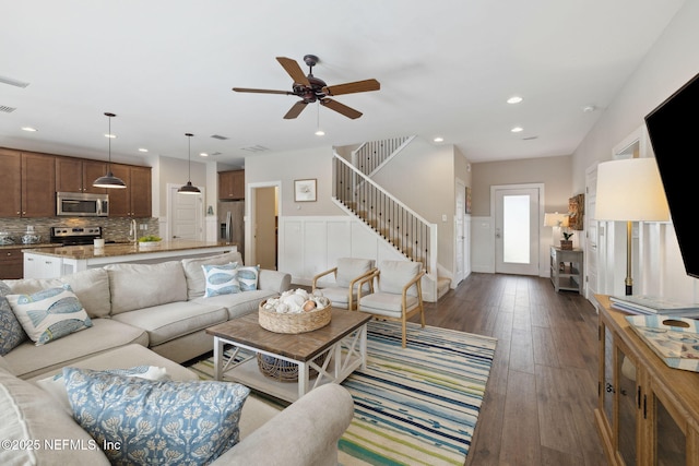 living area featuring dark wood-style flooring, recessed lighting, visible vents, stairway, and a ceiling fan