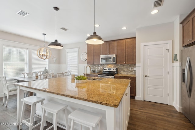 kitchen featuring appliances with stainless steel finishes, visible vents, and a sink