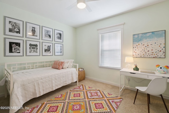 carpeted bedroom with a ceiling fan and baseboards