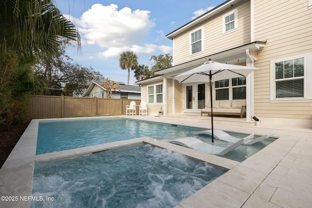 view of swimming pool with a fenced in pool, french doors, a patio, an in ground hot tub, and a fenced backyard