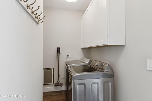 washroom with dark wood-style flooring, independent washer and dryer, cabinet space, and baseboards