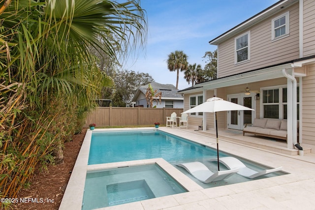 view of swimming pool featuring an in ground hot tub, a patio area, fence, and a fenced in pool