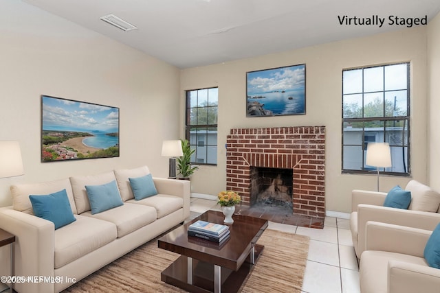 1360 Hart St, Jacksonville, FL 32209 - living room featuring light tile patterned floors, baseboards, a fireplace, and visible vents
