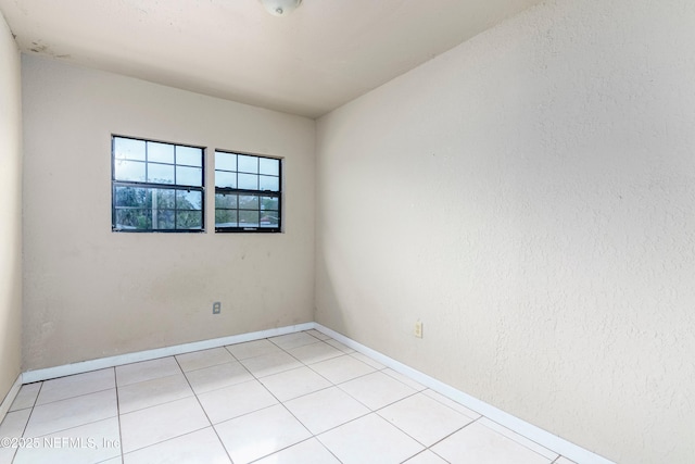 1360 Hart St, Jacksonville, FL 32209 - empty room with light tile patterned flooring and baseboards