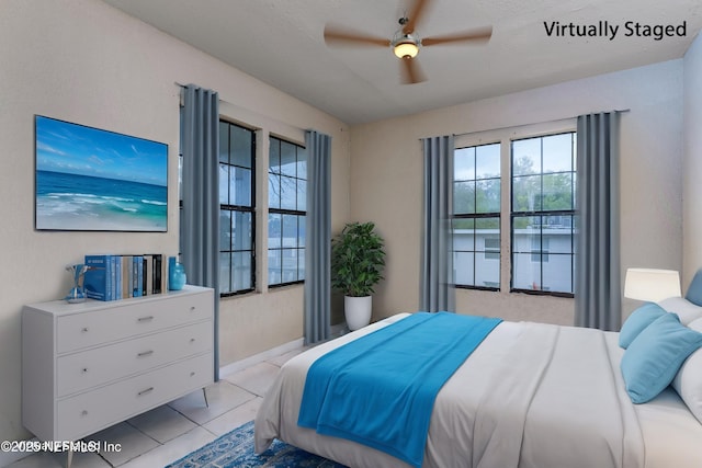 1360 Hart St, Jacksonville, FL 32209 - bedroom featuring light tile patterned flooring, baseboards, and a ceiling fan