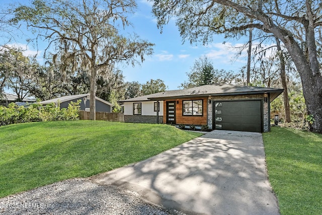 view of front of house featuring a front yard and a garage