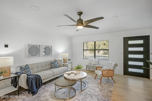living room with ceiling fan and light hardwood / wood-style floors
