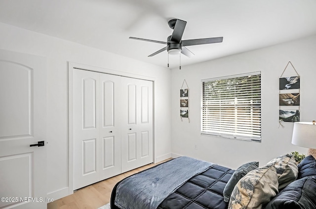 bedroom with a closet, hardwood / wood-style floors, and ceiling fan