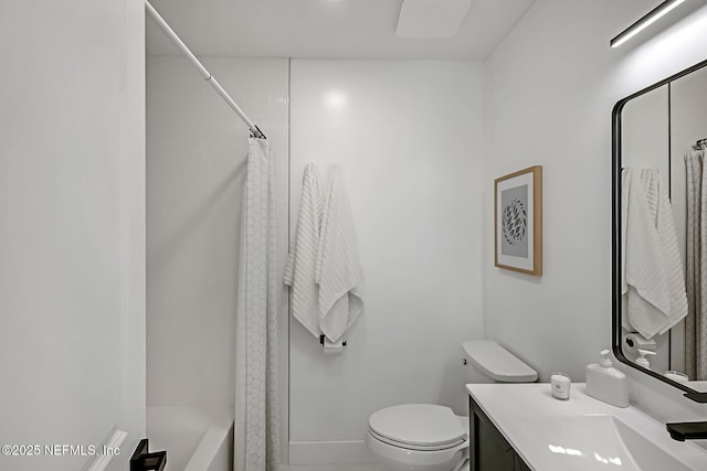 full bathroom featuring shower / bath combo, vanity, and toilet