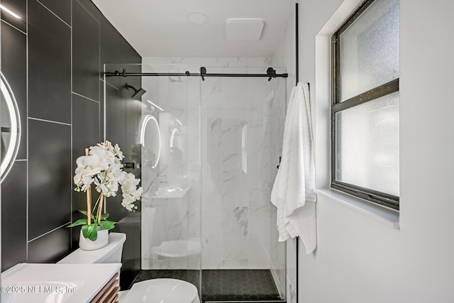 bathroom with vanity, an enclosed shower, and toilet