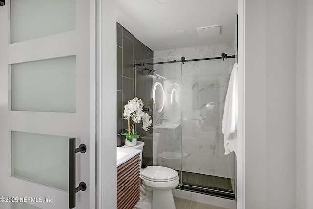 bathroom featuring vanity, an enclosed shower, and toilet