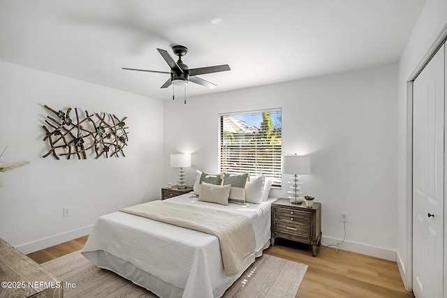 bedroom with ceiling fan, a closet, and light hardwood / wood-style floors