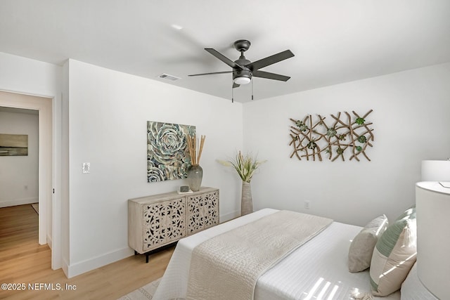 bedroom with ceiling fan and light hardwood / wood-style flooring